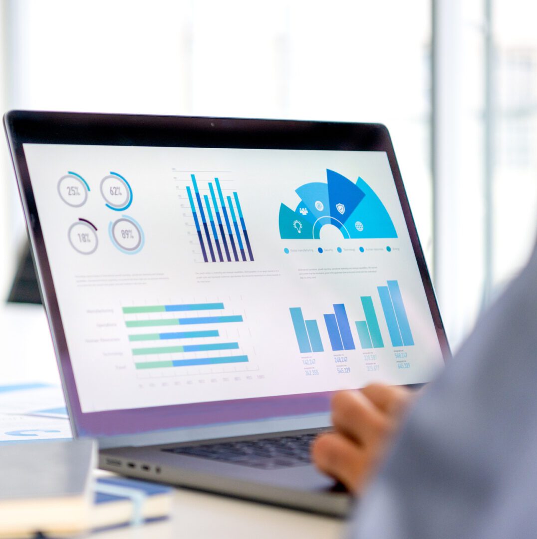 Laptop displaying various data charts.